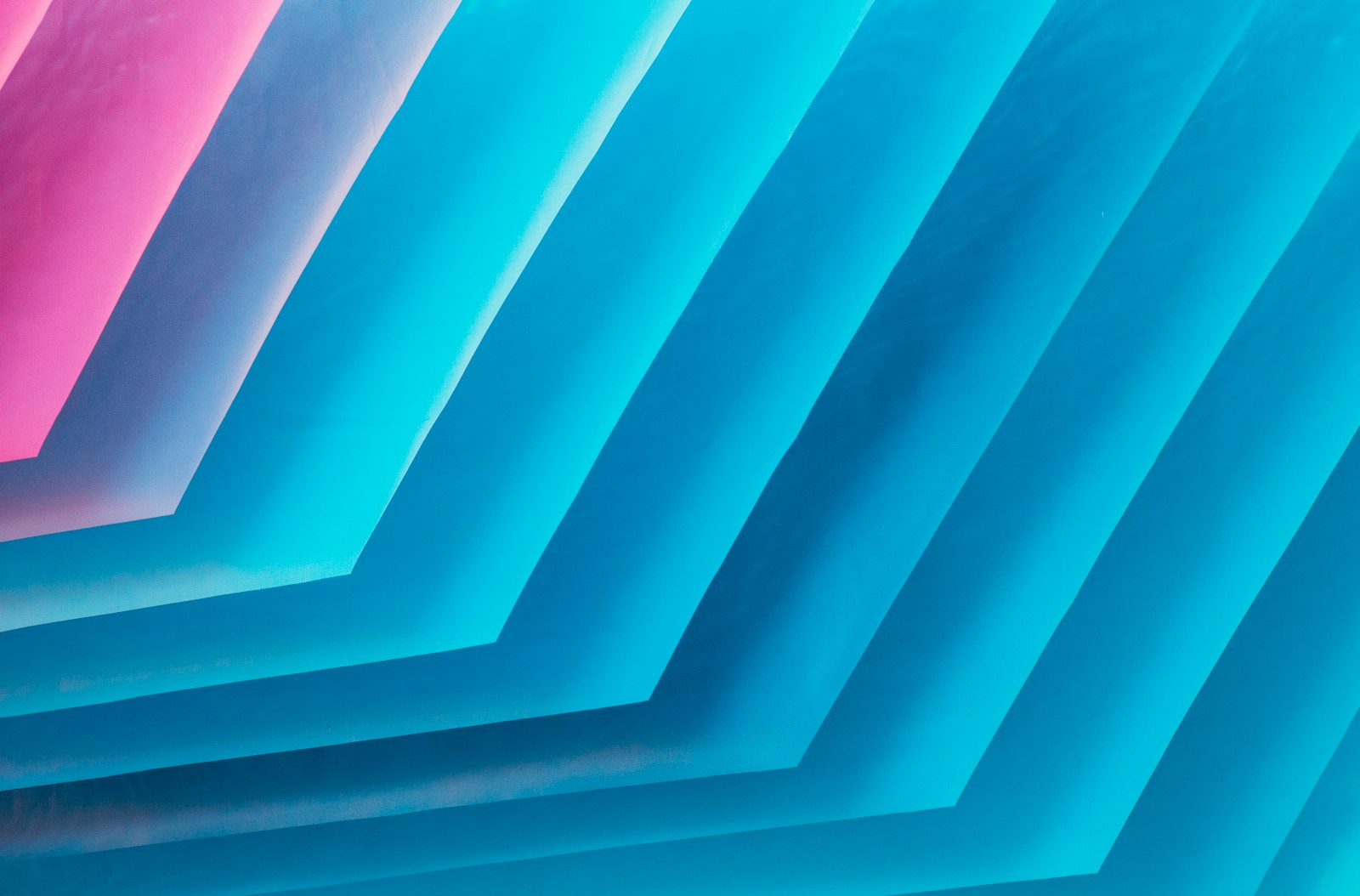 a bunch of blue and pink papers stacked on top of each other